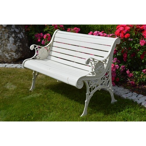 Garden bench with wooden slats and decorative cast iron seat...
