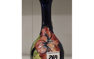 Moorcroft Hibiscus on blue vase. Height 22cm