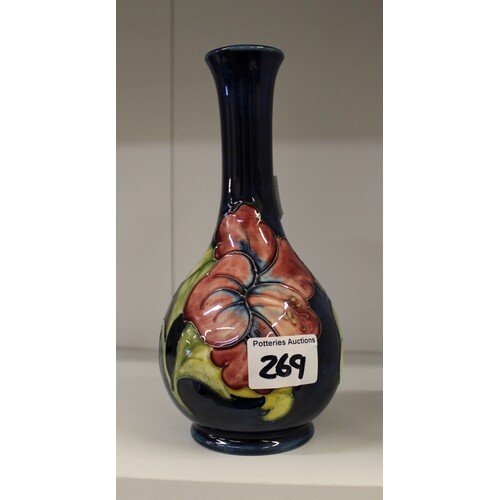 Moorcroft Hibiscus on blue vase. Height 22cm