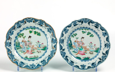 Pair of round porcelain plates with contoured edges....