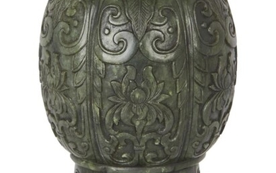 Property of a Gentleman (Lots 55-80) A Chinese spinach jade water pot, 18th/19th century, of lobed ovoid form, carved in low relief with six panels of lotus flowers beneath stiff leaves and scroll motifs, raised on a straight foot carved with ruyi...