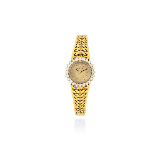 Rolex. A lady's 18K gold and diamond set manual wind bracelet watch