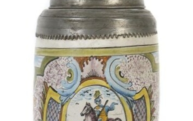 Roller jug with tin mounting Erfurt, lid dat. 1737, reddish-brown body, glazed, the conical wall decorated in hot-fire colours, the fond sprinkled with manganese, on top of it a frontal cartouche with depiction of St. Francis of Assisi. Georgs, framed...