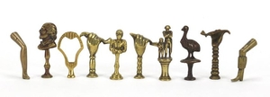 Ten antique pipe tampers including Napoleon, Shakespeare, jo...