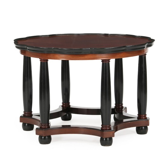 Unknown design: Coffee table of stained mahogany. Curved edge, legs and “feet” of black lacquered wood. Ca. 1930.