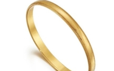 A 22ct. gold bangle, inner circumference 5.8cm,...