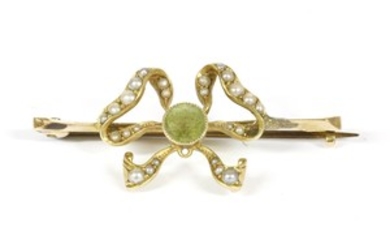 An Edwardian gold circular cut peridot and seed pearl bow brooch