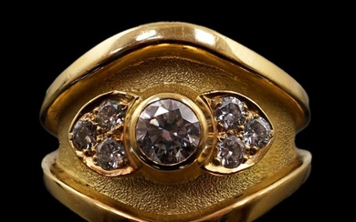 A 1990's part textured 18ct gold and collet set single stone...