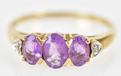 A 9ct yellow gold amethyst and diamond graduated ring, size...