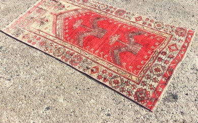 A Baluch wool prayer rug, the red ground with plant...