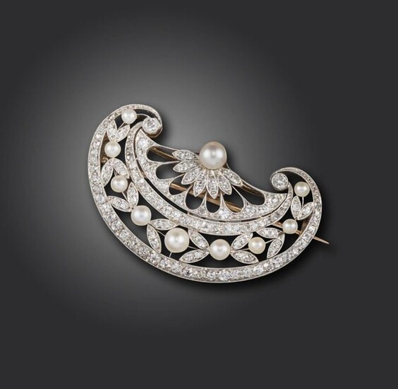 A Belle Epoque pearl and diamond brooch, the stylised fan is pierced and set with diamond and pearl laurels in platinum and gold, 4cm wide, detachable brooch fitting to reverse, fitted case
