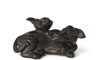 A Chinese bronze 'elephant' scroll weight Ming dynasty The recumbent animal naturalistically...