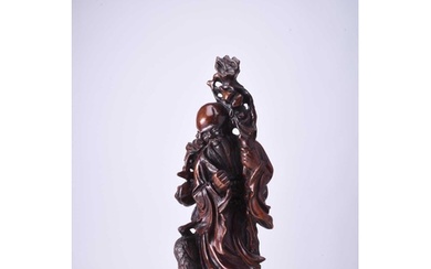 A Chinese carved hardwood figure of Shoulao, late Qing Dynas...