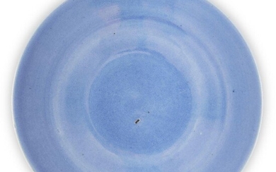 A Chinese monochrome blue-glazed dish, early 19th century, covered all-over in a pale blue glaze, 29cm diameter 十九世紀早期 天藍釉碟