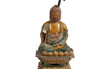 A Chinese sancai-glazed tileworks figure of a seated