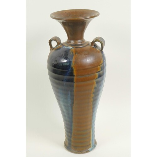 A Chinese stoneware baluster vase with rib formed body and t...