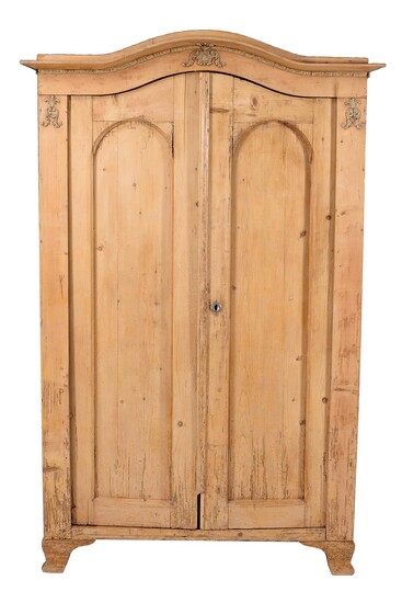 A Continental stripped pine and composition moulding mounted armoire