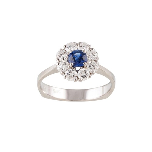 A DIAMOND AND SAPPHIRE CLUSTER RING, the circular sapphire t...