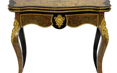 A French Louis XVI style gilt metal mounted flip top games table after Andr?-Charles Boulle circa