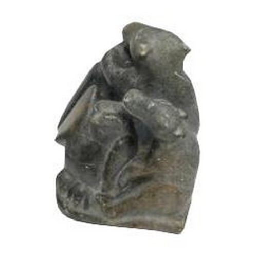 A GOOD INUIT POLISHED SOAPSTONE CARVING OF A GROUP COMPRISIN...