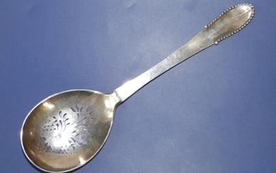 A Georg Jensen silver straining spoon with beaded edge...