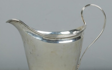 A George III silver sauce boat, with banded base. Partial as...