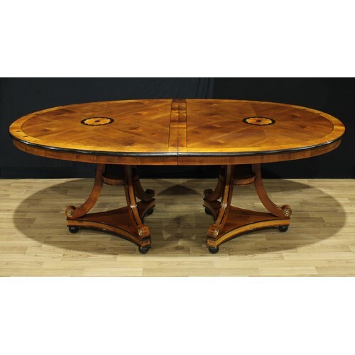 A George III style oval dining table, by repute purchased fr...