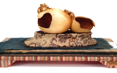 A JAPANESE CARVED IVORY OKIMONO OF TWO MICE ON AN EATEN PUMPKIN