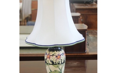 A Moorcroft pottery table lamp in the Daisy pattern, with sh...