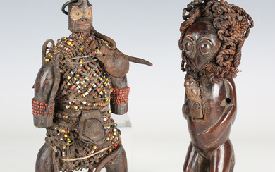 A Namji carved wooden fertility doll, Cameroon, covered in overall beaded strands and applied metal