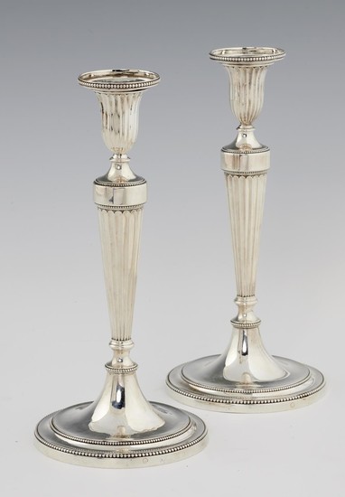 A PAIR OF GEORGE III NEO CLASSICAL SILVER CANDLESTICKS of f...
