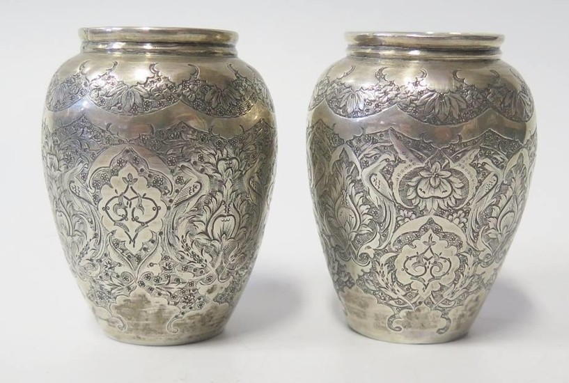 A Pair of Persian Silver Vases with chased foliate decoratio...