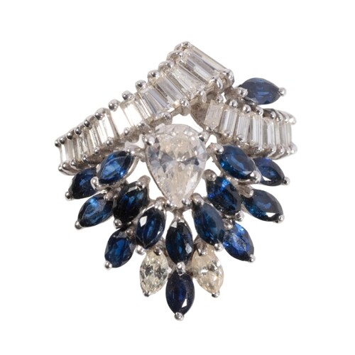 A SAPPHIRE AND DIAMOND CLUSTER RING the central pear-cut dia...