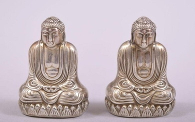 A SMALL PAIR OF SILVER BUDDHA SALT AND PEPPER VESSELS