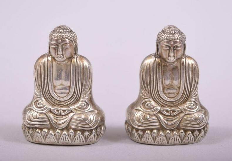 A SMALL PAIR OF SILVER BUDDHA SALT AND PEPPER VESSELS