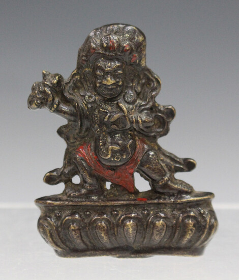 A Sino-Tibetan bronze diminutive figure of Mahakala, late Qing dynasty, cast standing on a lotus thr