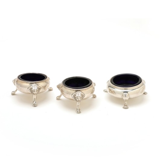 A Victorian silver salt cellar and two silverplated cellars, all with blue glass inserts. (3)