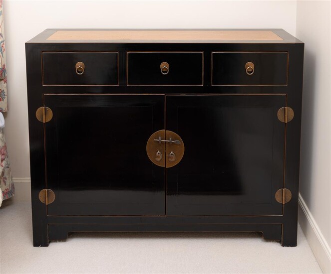 A black lacquered Chinese chest with three drawers and two...
