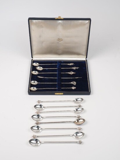 A cased set of six Brazilian spoons with novelty terminals, stamped 900, designed with twisted elongated stems and various motifs including bucking bronco, armadillo and pineapple to terminals, together with a set of eight Danish spoons with crown...