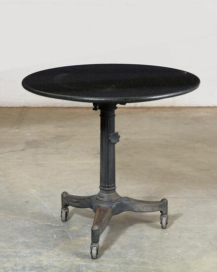 A cast iron and slate adjustable table