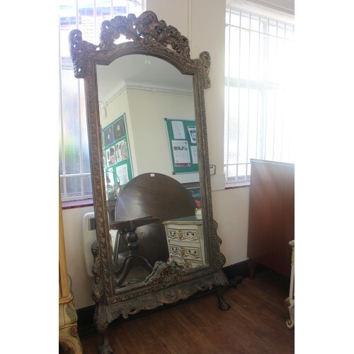 A continental reproduction freestanding hall mirror, in aged...