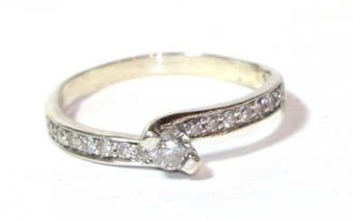 A diamond solitaire ring with diamond set shoulders, stamped '14K',...
