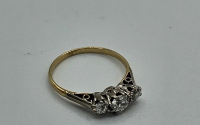 A diamond three stone ring. The principal stone is an...