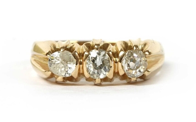 A gold three stone diamond ring