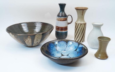 A group of six pieces of studio pottery, late 20th century, comprising: a large slip glaze bowl, 31.5cm diameter; a shallow bowl with blue/green glazed interior, 24cm diameter; a jug with loop handle, 28cm high; a vase with brown stripe glaze; 25cm...