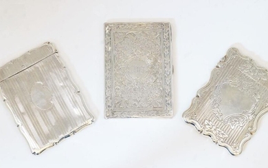 A group of three silver card cases, comprising: a Victorian example, Birmingham, 1876, probably Hilliard & Thomason, marks rubbed, with vine leaf decoration and central cartouche with engraved monogram, with lined interior, 9.6cm high, 6.9cm wide;...