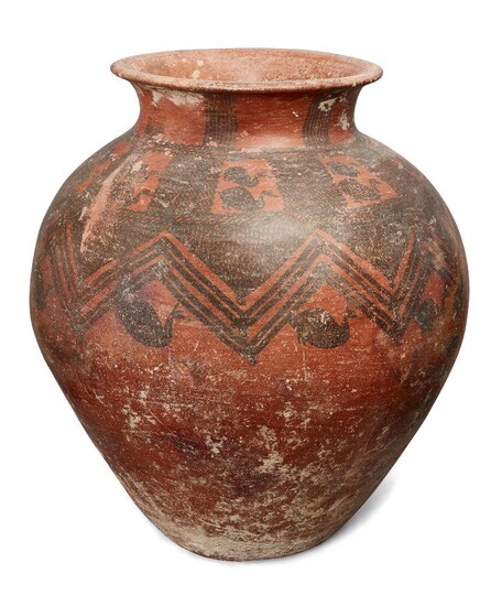 A large Anatolian pottery vessel, circa 2nd Millennium B.C., the rounded vessel tapering to the base and neck, with a flaring mouth, the red burnished ground decorated with black painted decoration composed of birds and cross-hatching around the...
