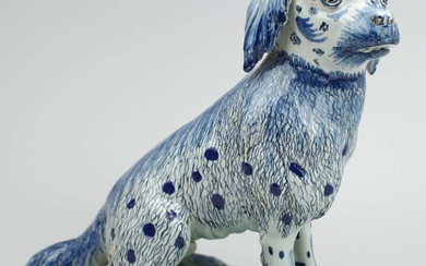 A large Delft pottery figure of a sitting dog
