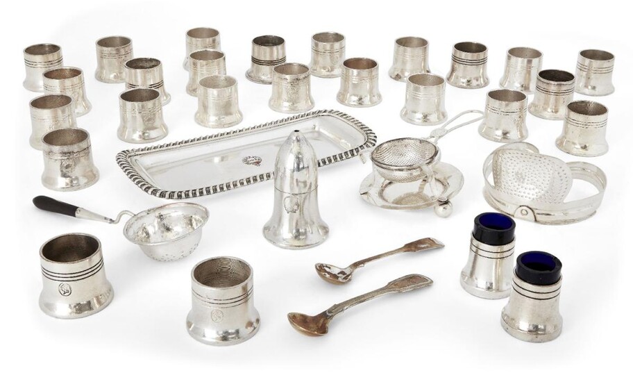 A large quantity of silver plated cruets, some with blue glass liners, each with the Athenaeum Club crest to side, together with a strainer designed to fit the collar of a jug, two further strainers and a small rectangular tray (a lot) Note: The...