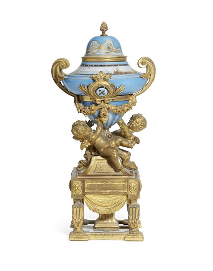 A late 19th century French gilt spelter mounted porcelain covered urn by Phillipe H. Mourey (French, 1840-1910)